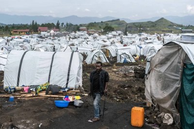 A man walks through the Bulengo displacement camp on the outskirts of Goma. Aid groups and displaced people say the camps are overcrowded and lack basic services.