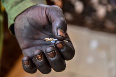 A man carrying a roll of heroin in the hand.