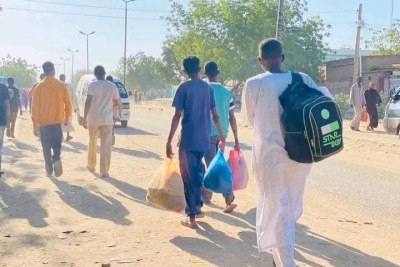 People fled Wad Madani on foot on December 16, 2023.