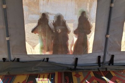 Children peer through a UNICEF tent at a child-friendly space in Kassala state, Sudan.