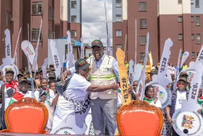 President William Ruto celebrates during the commissioning of the New Mukuru Housing Estate.