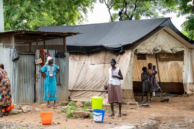 Patients' caretakers stand at the MSF water point in the MSF outpatient department in Kule camp. Ethiopia, July 2025