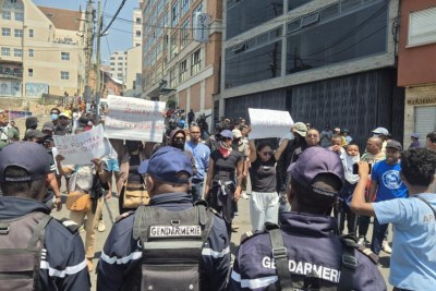 Protesters wave placards near Ambohijatovo Square in Antananarivo, on 25 September 2025.