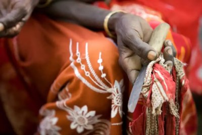 Boko Mohammed, a former excisor (a practitioner who performs female genital mutilation), holds the tool she used to perform the procedure at a community meeting in Kabele Village, in Amibara District, Afar Region.