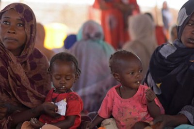 Two malnourished children receive food supplements at a health centre in Tawila, North Darfur, Sudan.
