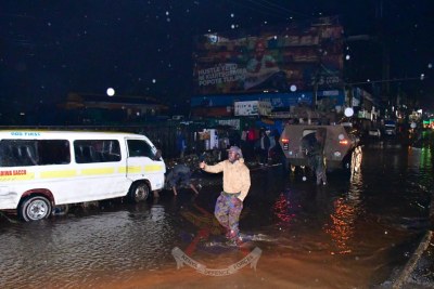 A Kenya Defence Forces (KDF) officer assists residents during severe flooding in Nairobi/KDF