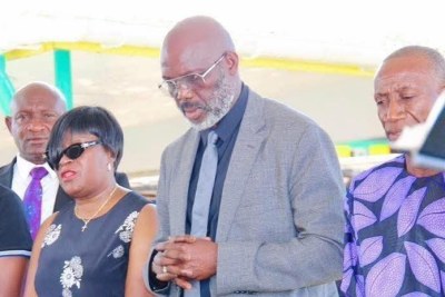 Former President Weah at the reburial ceremony of his late father.