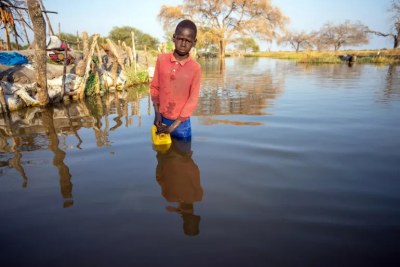 13-year-old Mathiei Makuol collects dirty water from the floodwater in the village of Panyagor in Twic East, Jonglei State in South Sudan.
