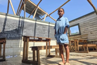 Christianah, 11, stands in her secondary school classroom which was destroyed by Tropical Storm Jude in the Grand Sud region of Madagascar in March 2025.